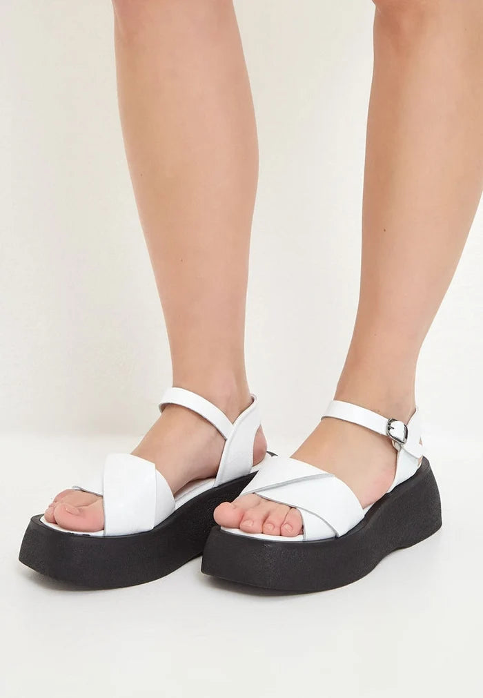 A stylish pair of white leather platform sandals, perfect for adding a chic touch to any outfit.