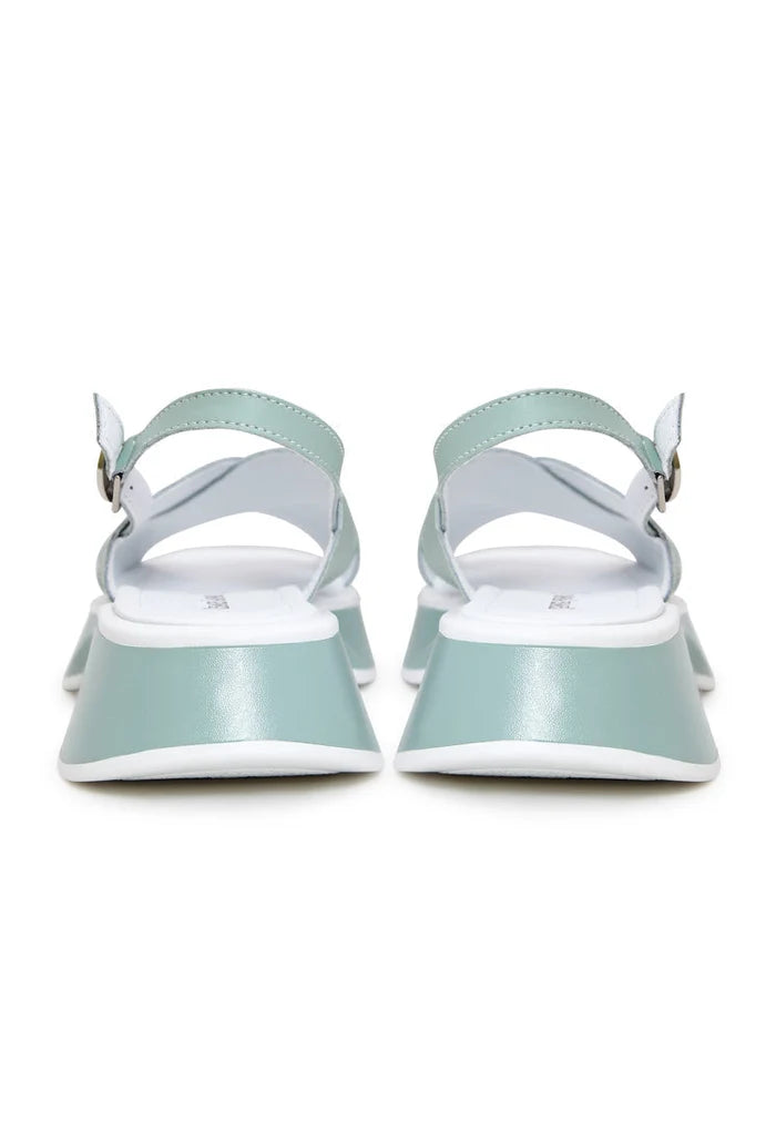 A trendy pair of green leather platform Tuti sandals for women - the perfect choice for stylish summer footwear.