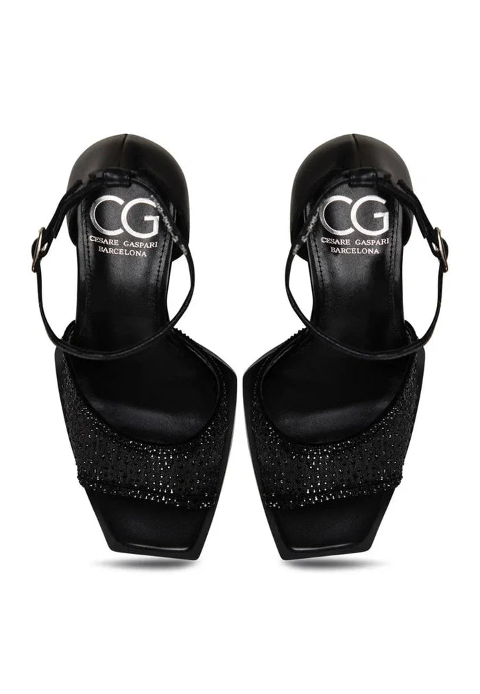 A pair of elegant ankle-strap heels in luxurious black with sparkling crystals, the perfect addition to elevate any outfit.
