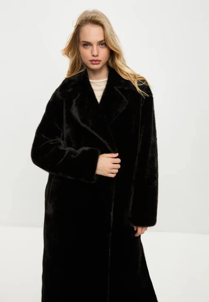 A fashionable black Freya faux fur coat, a luxurious must-have for winter fashion.