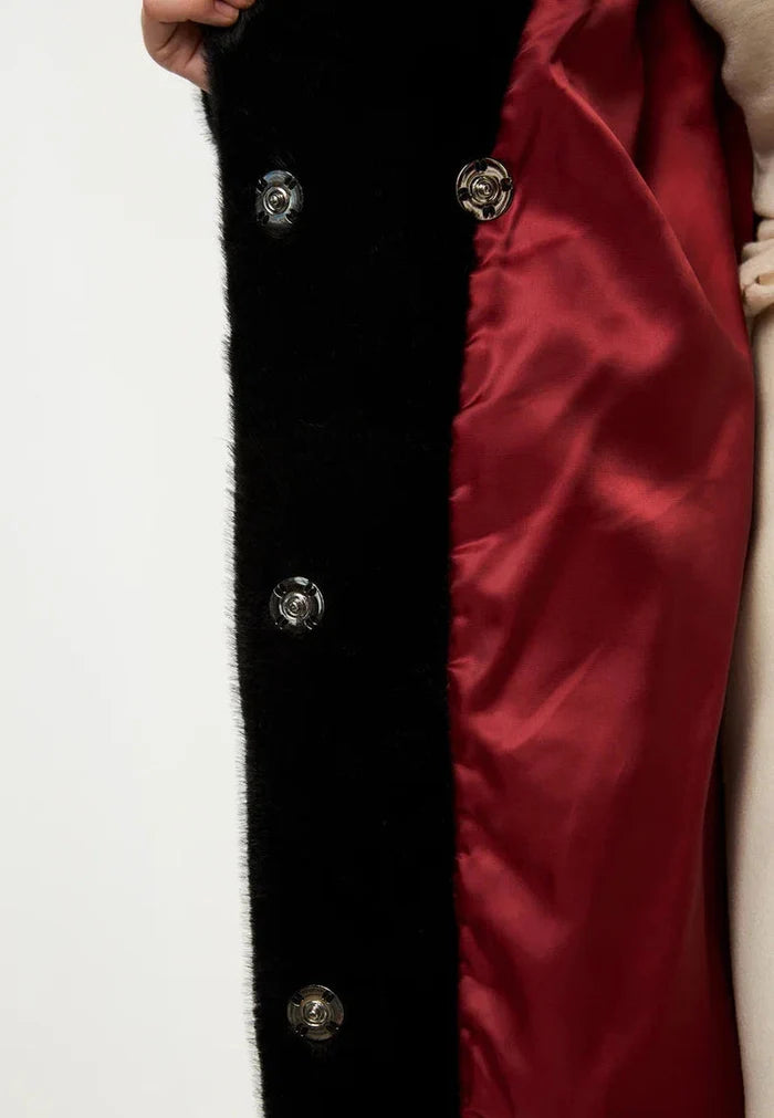 A fashionable and cozy black faux fur Freya coat, the epitome of luxurious winter fashion.
