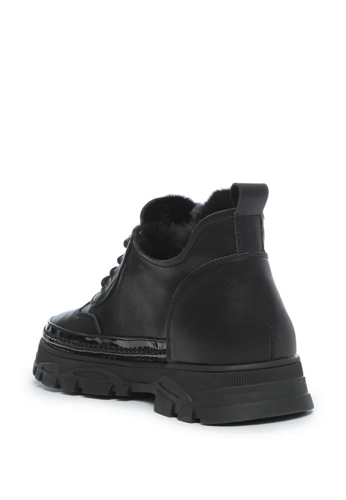 A stylish pair of black chunky sneakers with a cozy merino wool lining for ultimate comfort and warmth.