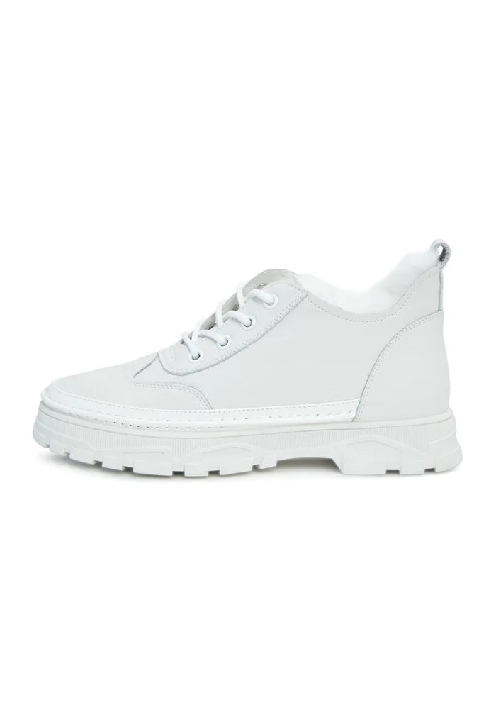 A trendy pair of chunky white sneakers featuring a cozy merino wool lining, combining style and comfort in this must-have merino wool footwear option with a chunky sole design.