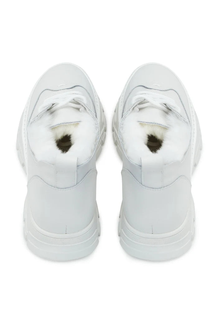 A pair of chunky white sneakers with a cozy merino wool lining, perfect for staying warm and stylish during chilly days.