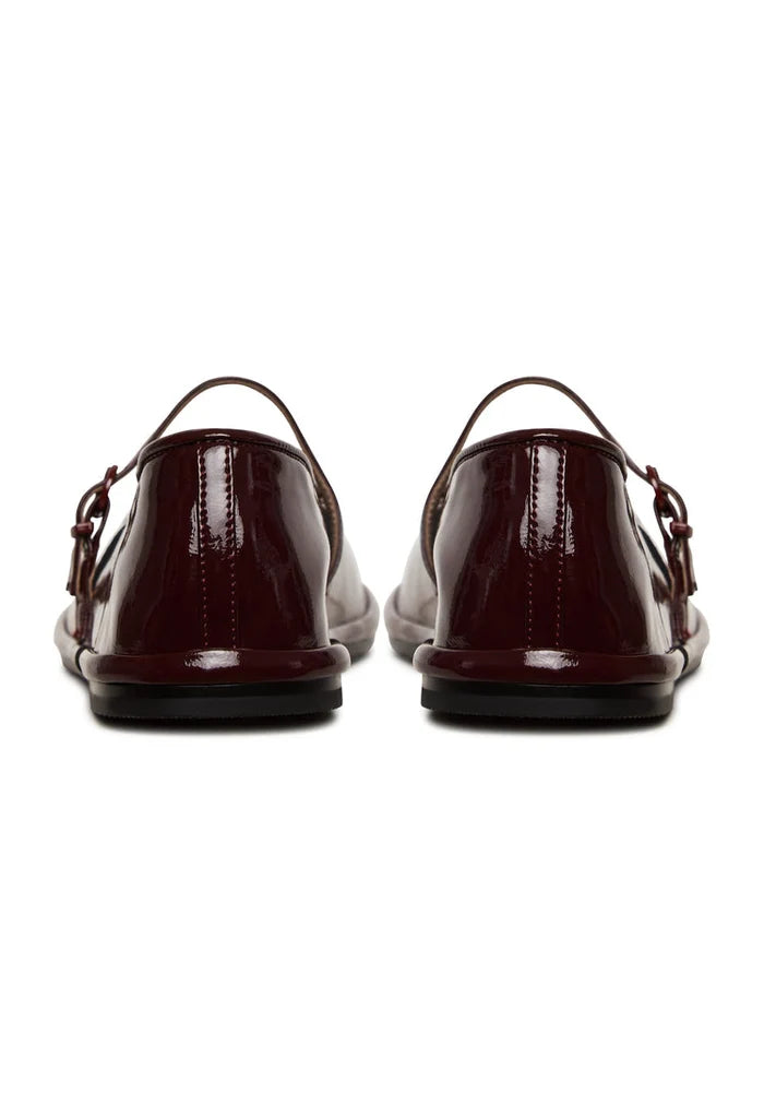 A stylish pair of minimalist Bordeaux shoes, also known as charm flats, ideal for anyone looking for elegant and versatile footwear.