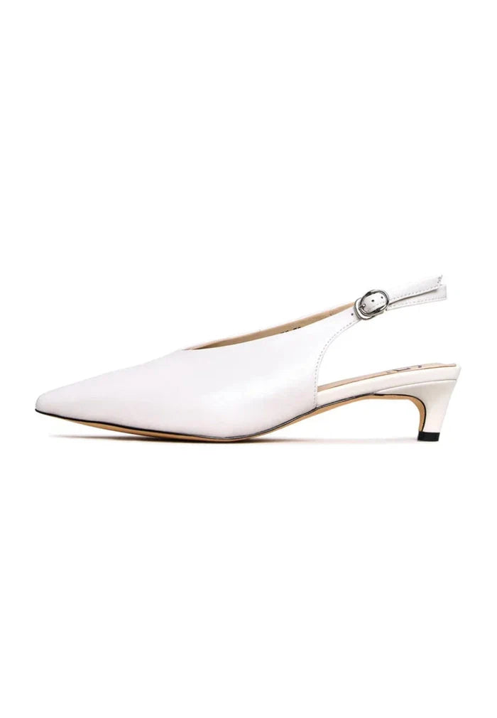 A chic pair of white minimalist kitten heels, the must-have stylish footwear every woman needs in her closet for a minimalist fashion look.