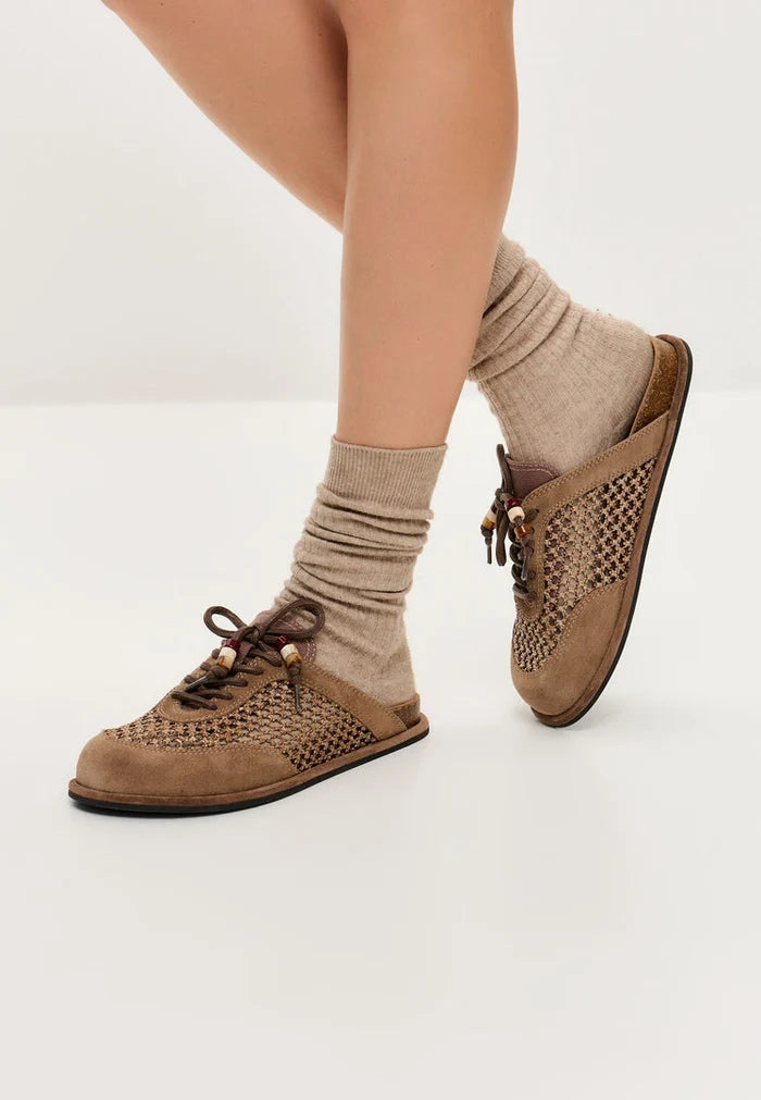 A pair of stylish and comfortable open-back mules, known as Nomad Breeze shoes, perfect slip-on mules for casual and chic footwear looks.