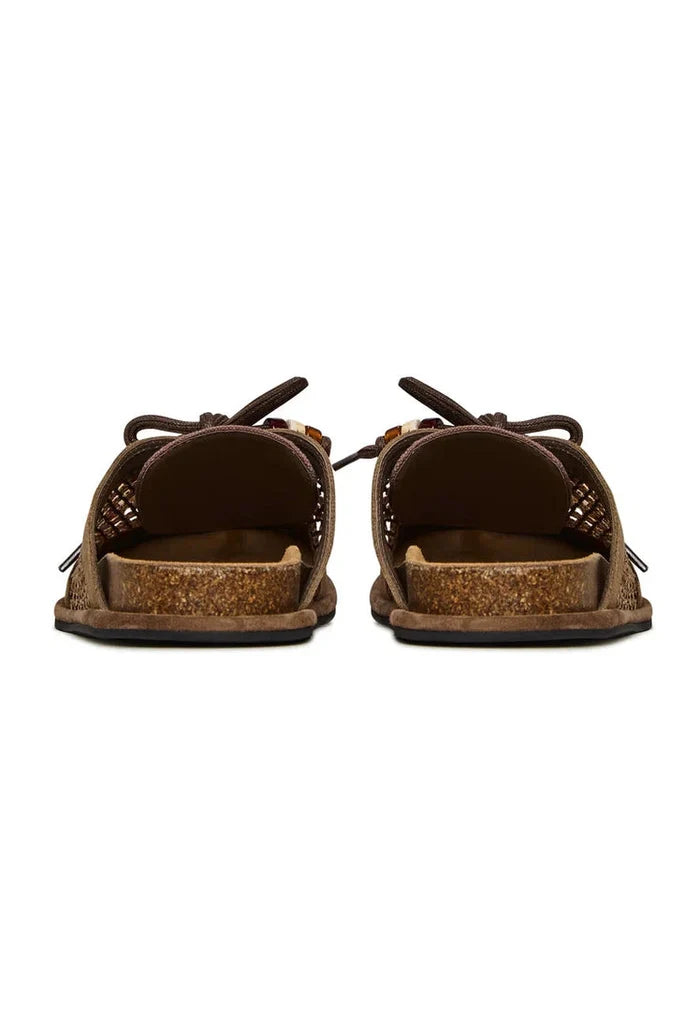 A pair of stylish and comfortable open-back mules, the Nomad Breeze shoes, perfect slip-on footwear for any occasion.
