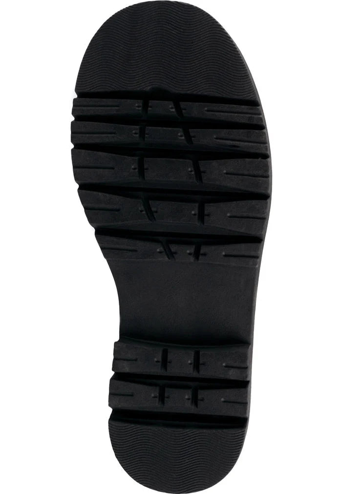 A stylish woman wearing trendy over-the-knee chunky boots, a must-have for the fall/winter season in women's fashion.