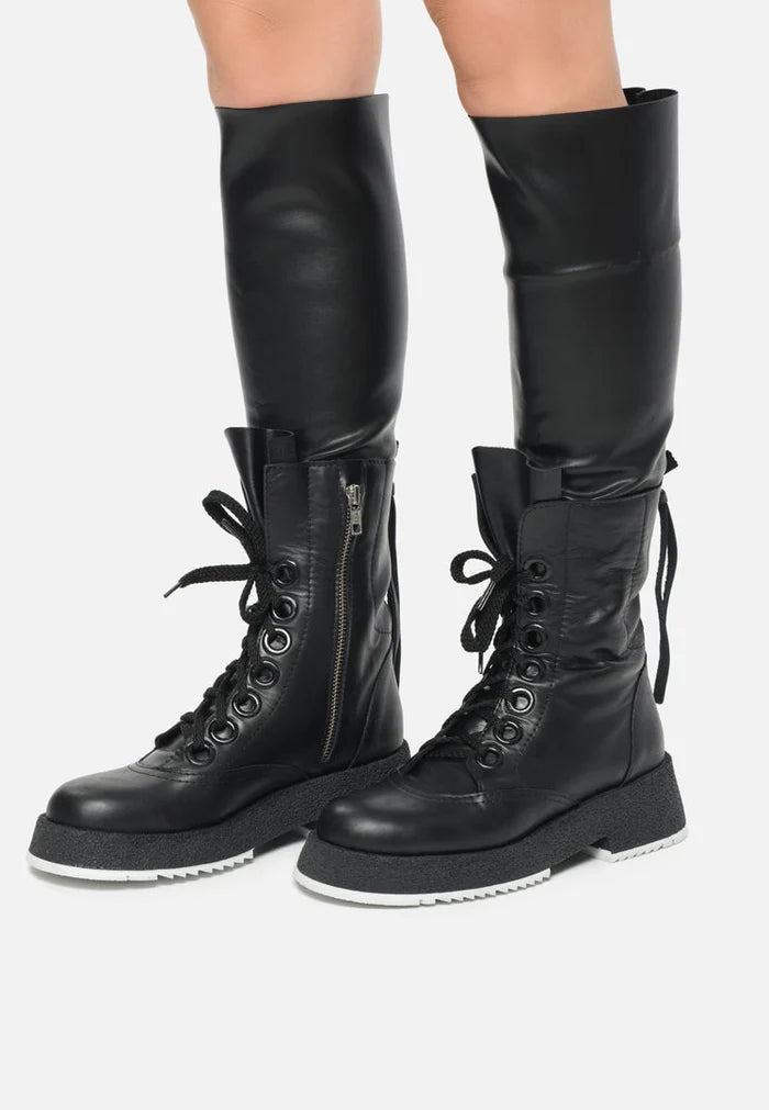 A variety of women's fashion boots including over-the-knee, lace-up combat, and knee-high lace-up boots - trendy combat footwear for stylish looks.