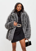 A fashionable woman wearing an elegant grey faux fur coat, the perfect luxurious winter outerwear for women.