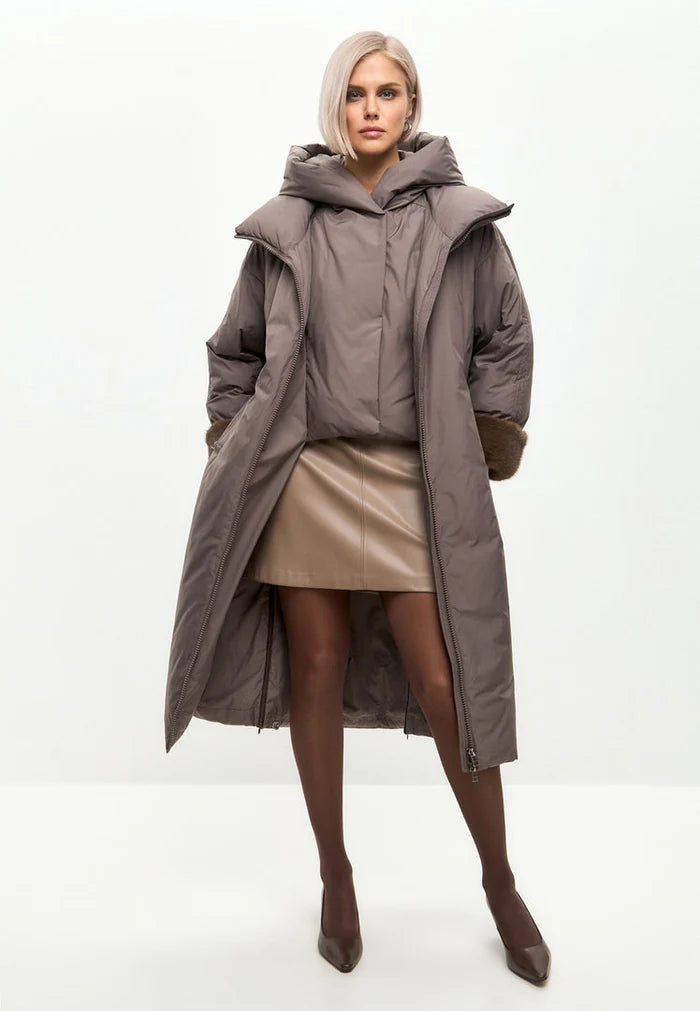 A stylish and cozy oversized hooded puffer coat in beige, featuring trendy faux fur cuffs, perfect as women's winter outerwear.