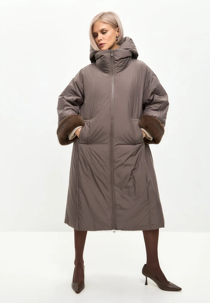 A fashionable beige oversized hooded puffer coat with faux fur cuffs, the perfect trendy outerwear for women's winter fashion.