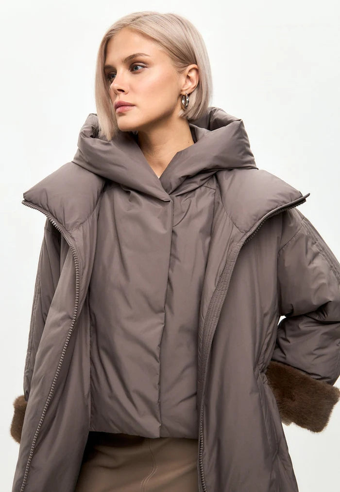 Stay warm and stylish this winter with an oversized hooded puffer coat featuring faux fur cuffs in a chic beige color - the perfect trendy outerwear for women.