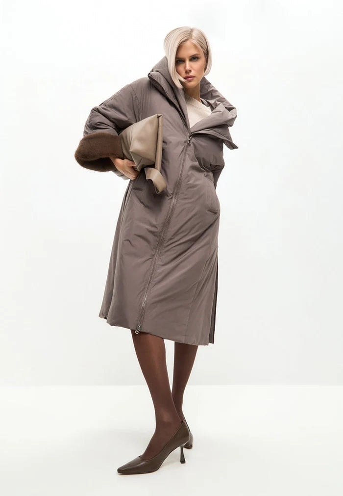 A stylish oversized hooded puffer coat in beige with faux fur cuffs, perfect for women's winter fashion and trendy outerwear.