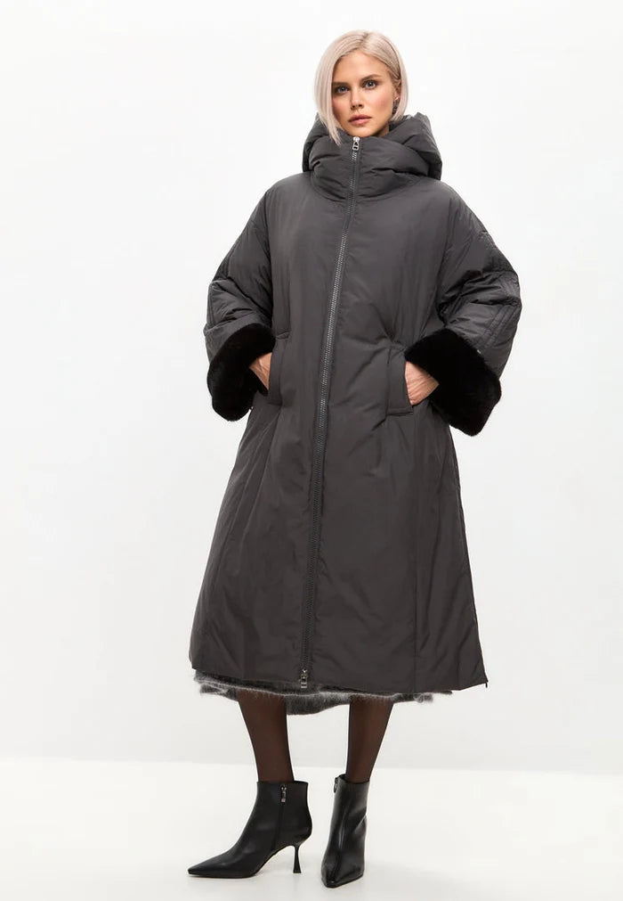A stylish gray oversized hooded puffer coat with faux fur cuffs, perfect for cold weather. This plus size women's fashion jacket is a must-have for winter.