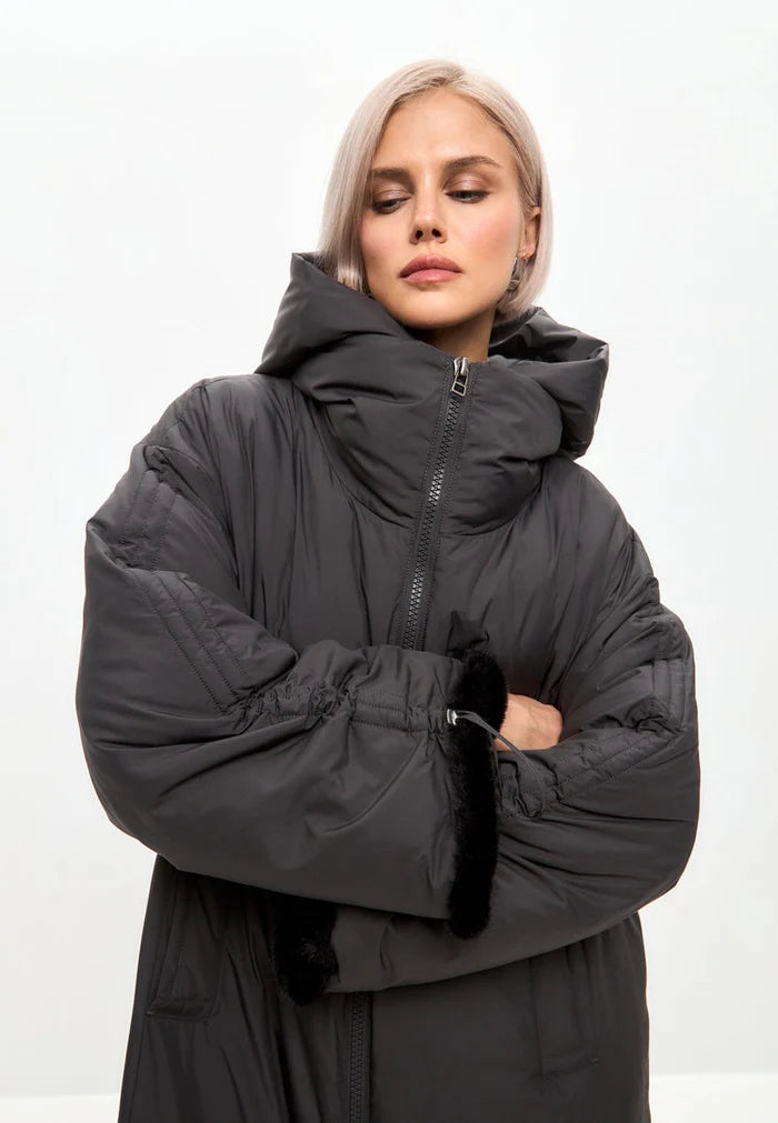 A stylish gray oversized hooded puffer coat with faux fur cuffs, ideal plus size outerwear for winter, a must-have in women's fashion jackets.