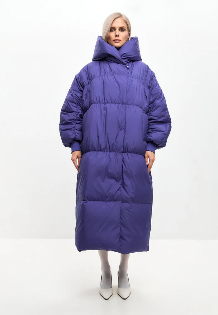 A trendy and stylish oversized puffer coat in violet, perfect for winter. Ideal for women looking for a plus-size, fashionable outerwear jacket.