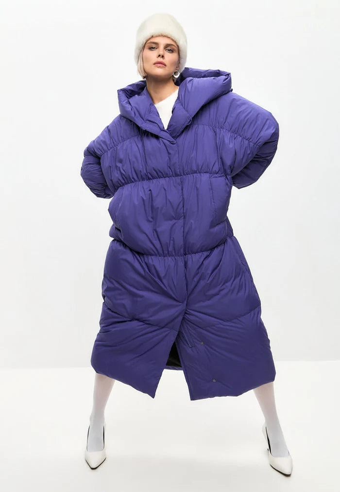 A stylish violet oversized puffer coat for women, a fashionable and warm plus-size outerwear jacket perfect for the winter season.