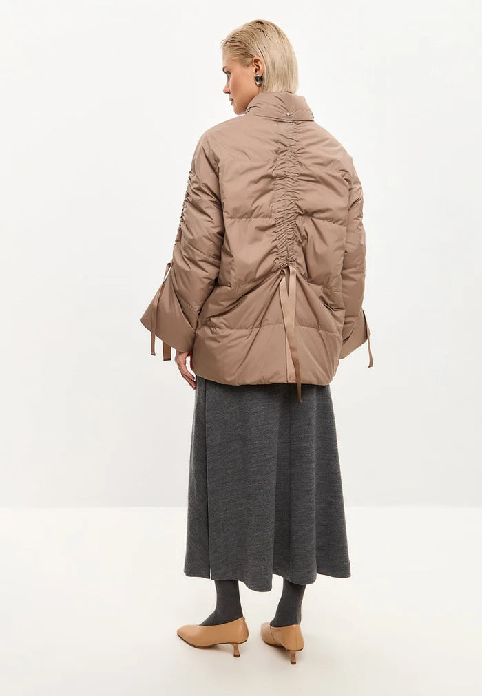 A stylish and cozy beige oversized quilted puffer jacket, perfect for staying warm and fashionable in the winter.