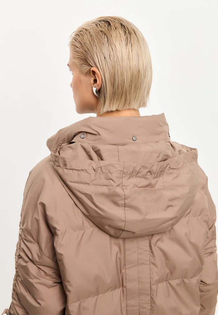 A fashionable beige oversized quilted puffer jacket, ideal for staying warm and stylish in the winter season.
