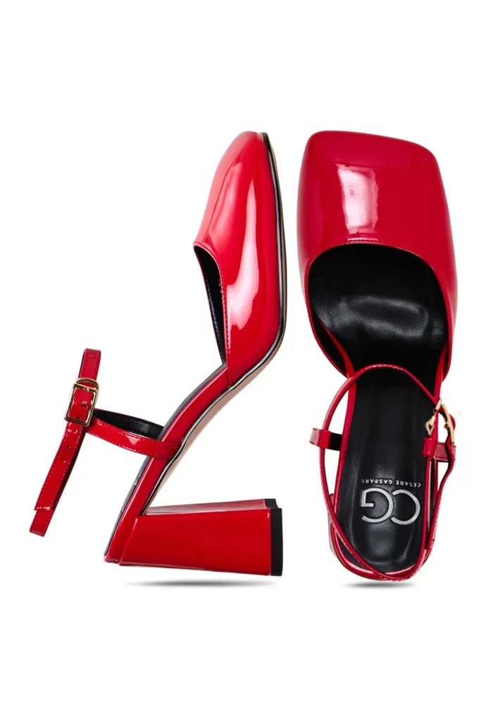 A stylish pair of red patent block heel pumps made of shiny patent leather for a bold and fashionable look.