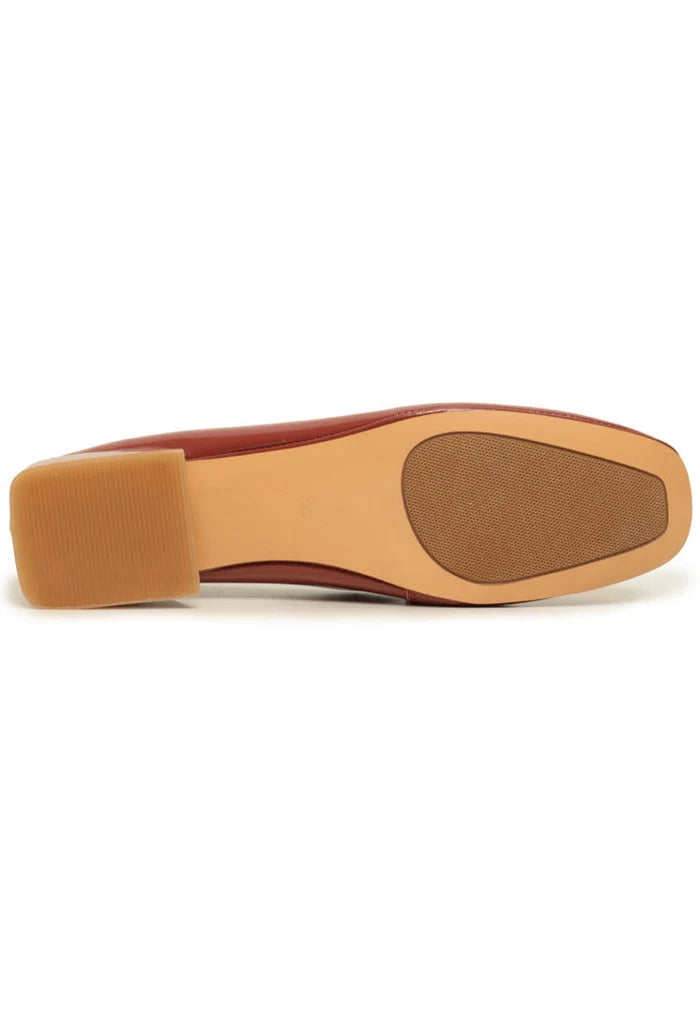 A stylish pair of patent leather loafers with metallic accents in vibrant orange, perfect for slipping on for a touch of fashion flair.