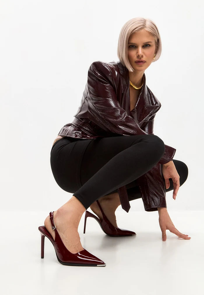 A stylish pair of red patent leather slingback pumps, perfect for adding a pop of color to any outfit.