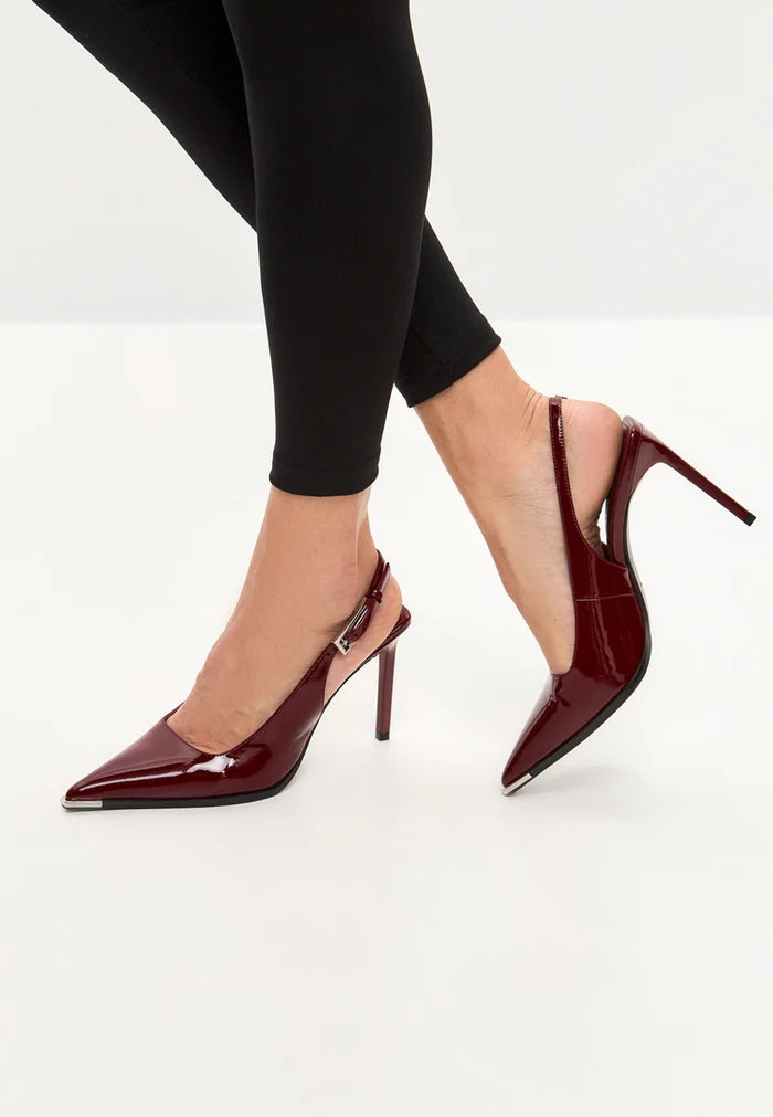 A close-up image of women's red patent leather slingback pumps, showcasing stylish red patent leather heels with a sleek and elegant design.
