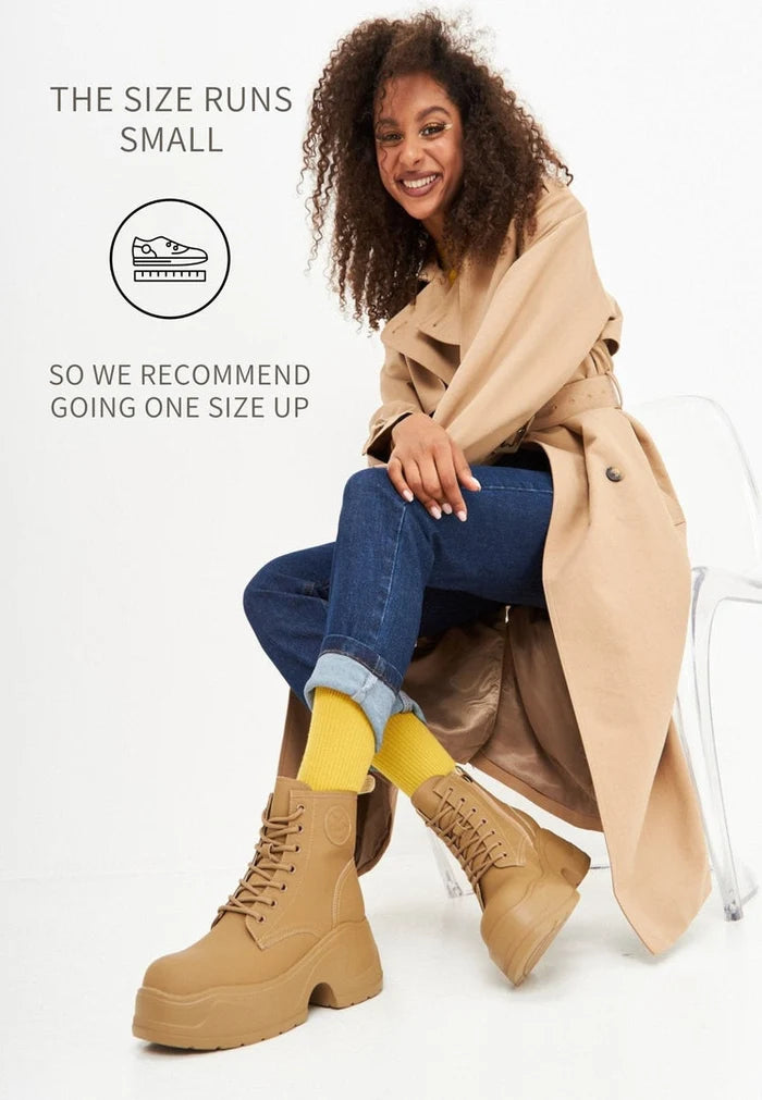 A trendy pair of women's platform ankle boots in beige, perfect for any fashion-forward wardrobe.