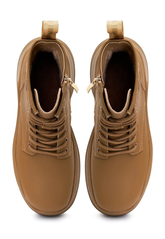 A stylish pair of beige platform ankle boots for women, perfect for adding a fashion-forward touch to any outfit.