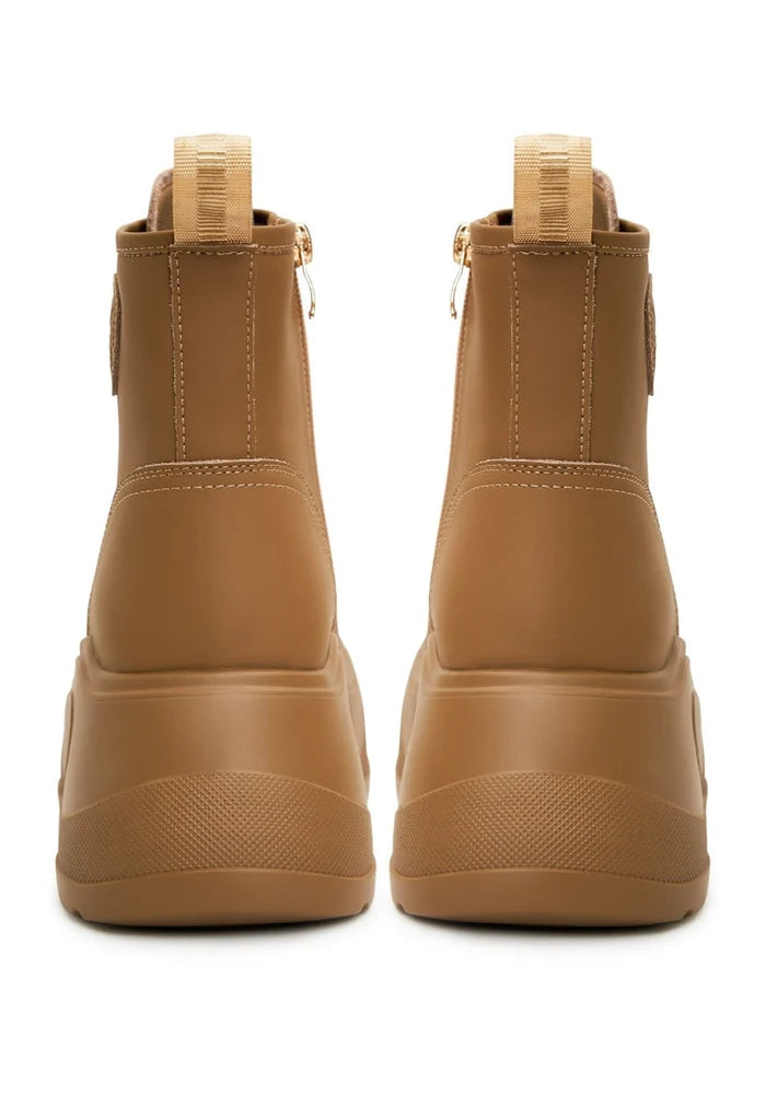 A trendy pair of beige platform ankle boots for women, perfect for fashion-forward individuals looking for designer footwear.