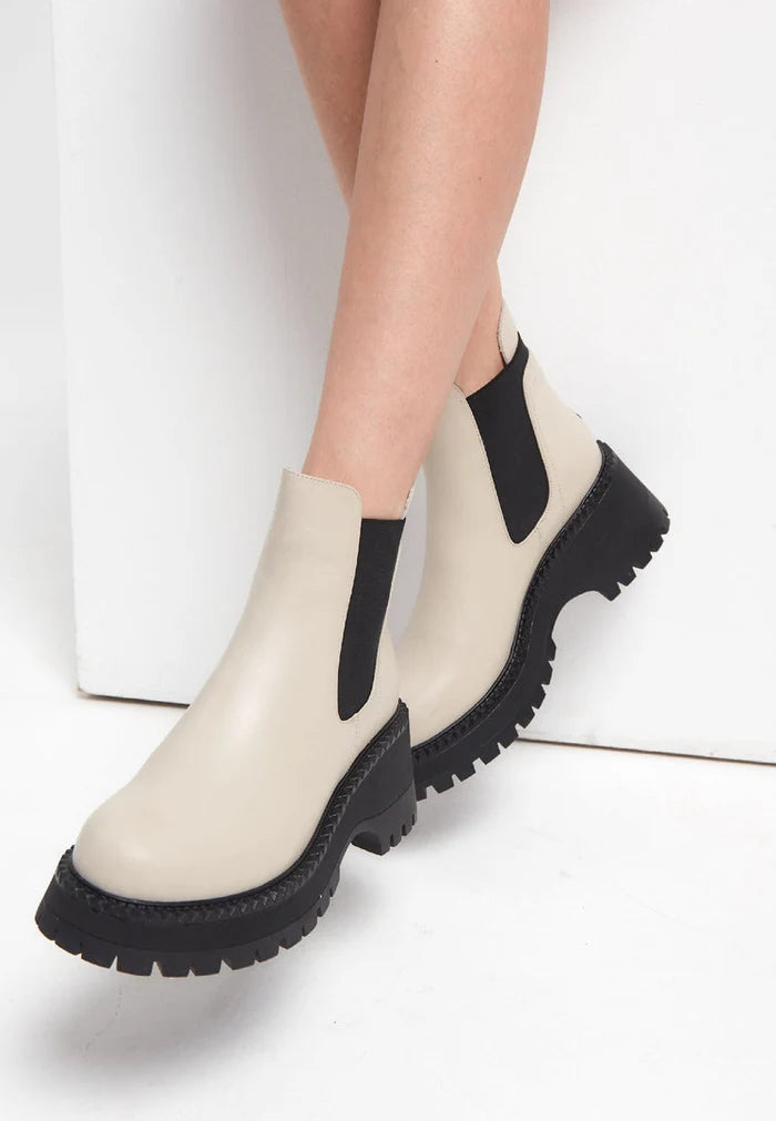 A stylish pair of women's fashion Chelsea boots in a chunky platform design, featuring a trendy beige color.