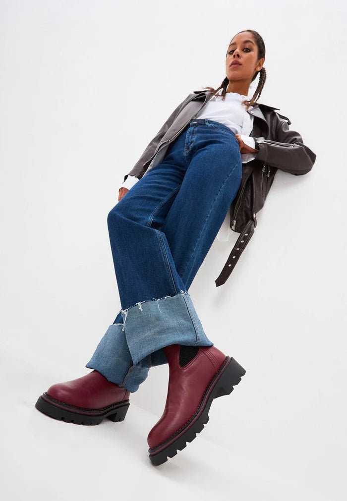 A stylish pair of Bordeaux ankle boots for women - a classic and fashionable choice crafted by a designer.