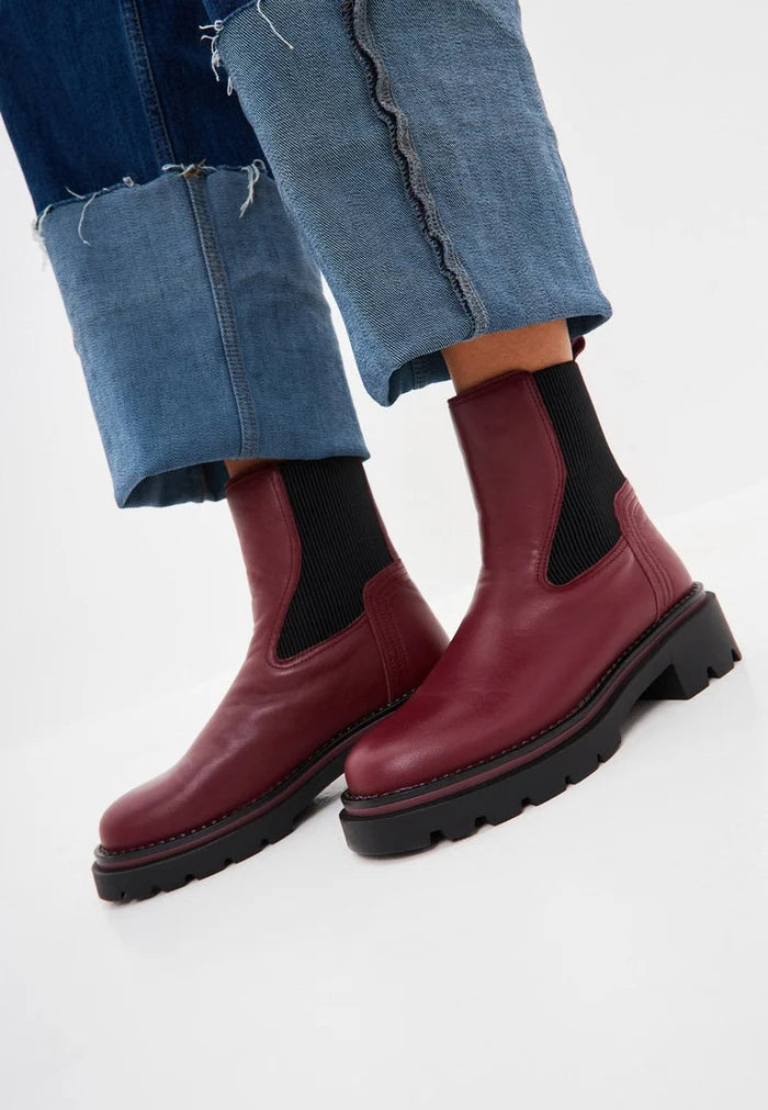 A pair of elegant bordeaux ankle boots for women - a classic and fashionable choice that exudes designer style.