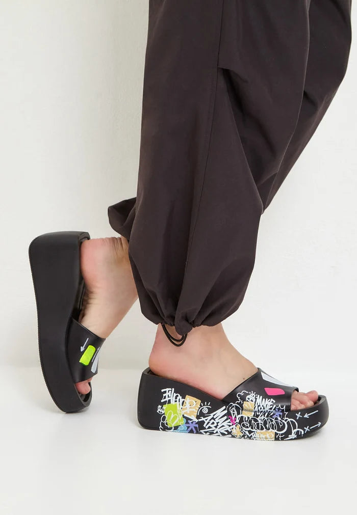 A stylish and fashionable pair of black platform mule shoes for women, featuring high heels and trendy design.