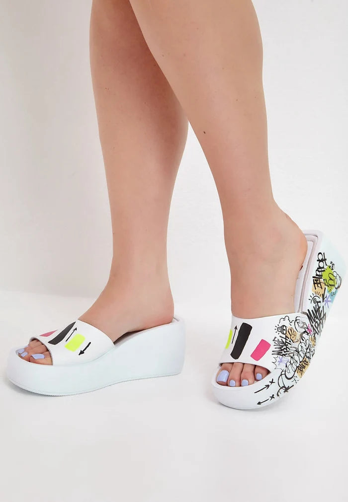 A stylish pair of white platform mule shoes with a chic design, perfect for any outfit or occasion.