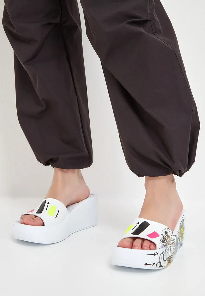 A stylish pair of white platform mule shoes, perfect for any fashionable outfit.