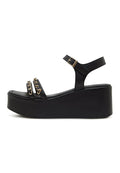 A stylish pair of black platform sandals for women with eye-catching gold chain accents, perfect for a fashionable and chic look.