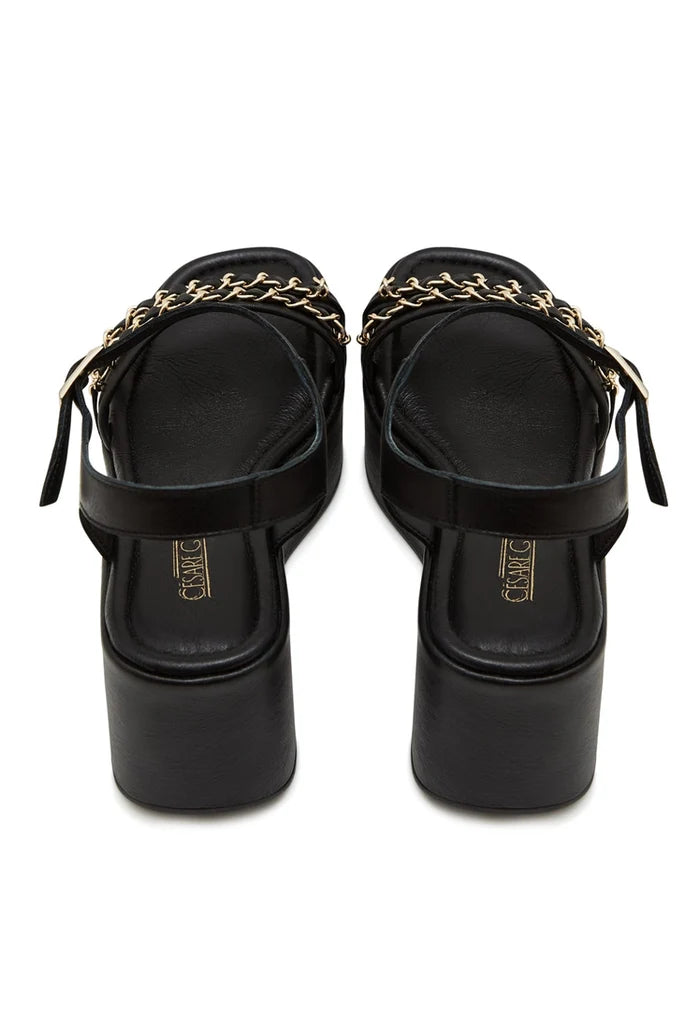 A stylish pair of women's black platform sandals with eye-catching gold chain accents, a must-have for trendy and fashionable footwear enthusiasts.