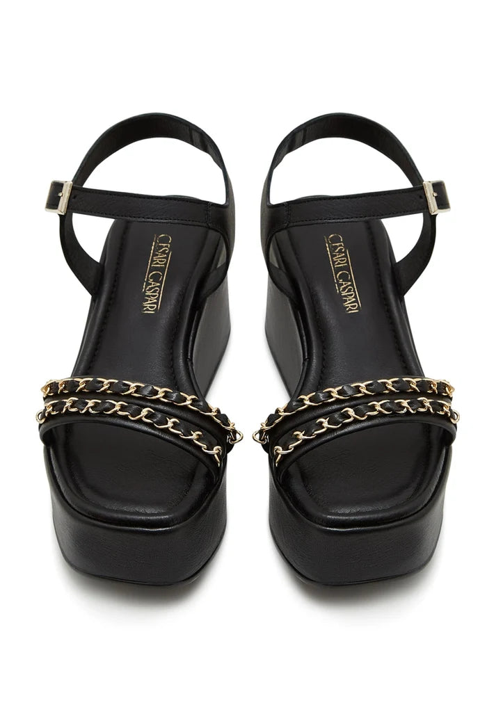 A stylish pair of black platform sandals for women with chic gold chain accents, perfect for trendy and fashionable shoe lovers.