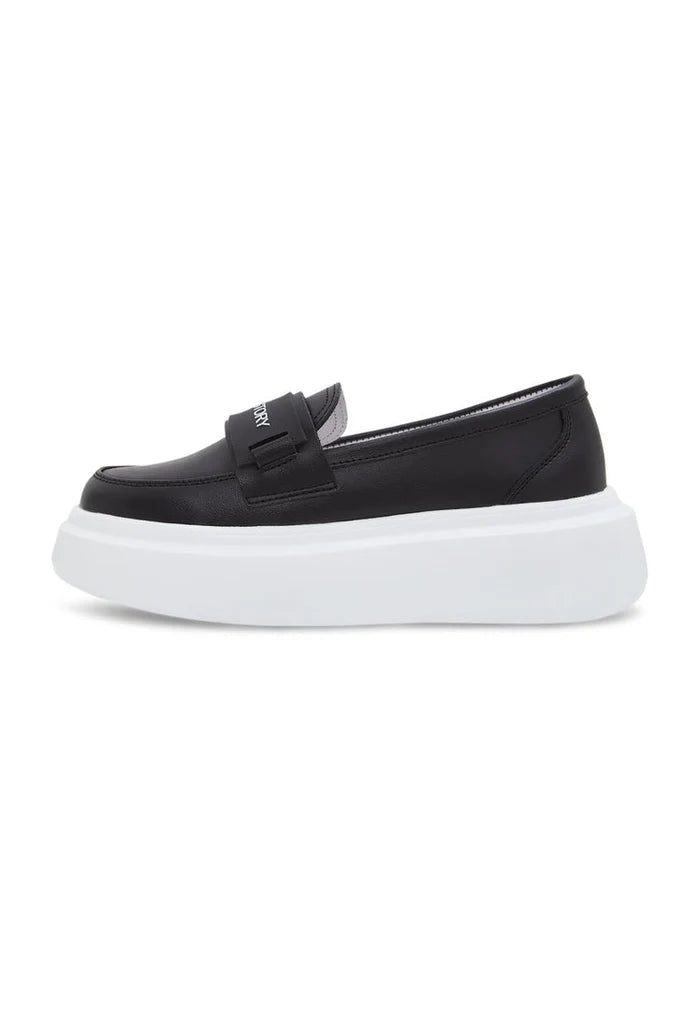 A trendy pair of black slip-on loafers with a platform sole, perfect for women's fashion footwear.