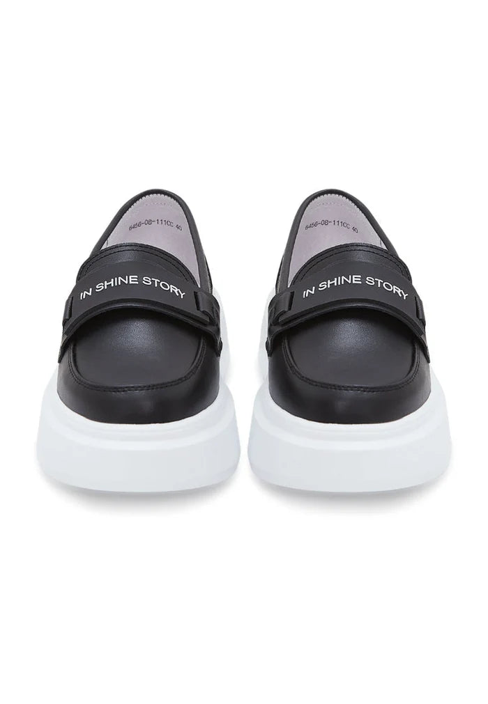 A stylish pair of slip-on black platform loafers, the perfect choice for women's fashion footwear.