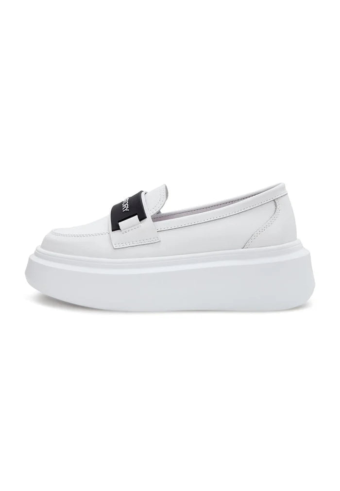 A pair of stylish slip-on platform shoes in white, perfect for women's casual footwear.
