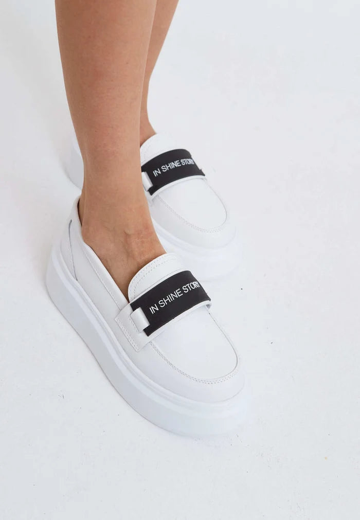 A stylish pair of slip-on platform white loafers for women's casual footwear fashion.