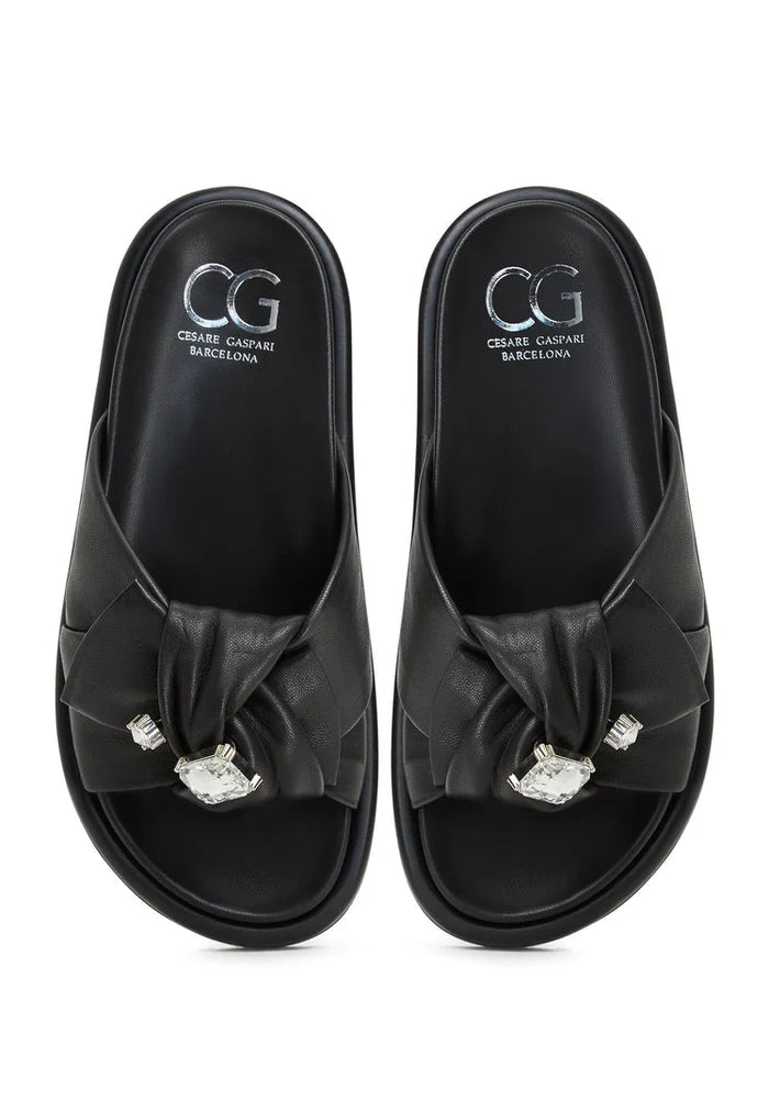 A stylish pair of black platform slippers, also known as Fernanda slippers, for women. These trendy slide sandals are versatile and comfortable footbed sandals.
