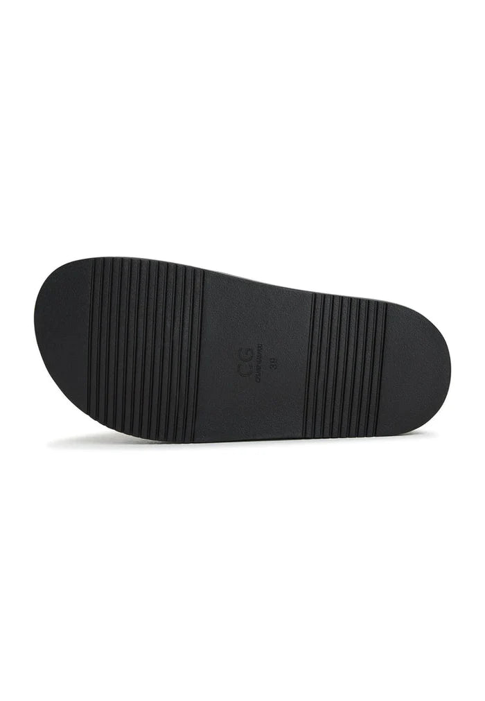 A close-up image of black platform slippers with a stylish design, known as Fernanda slippers, perfect for women's footbed sandals trend.