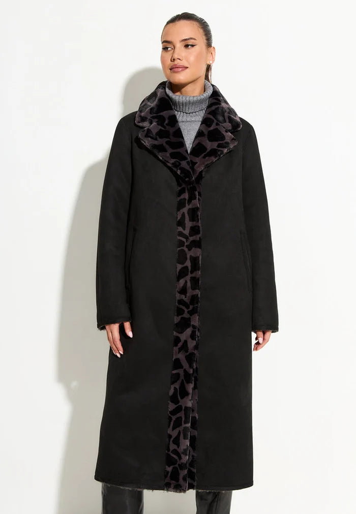 A stylish and cozy reversible Pantera faux fur coat in black, the perfect animal print outerwear for a fashionable winter look.