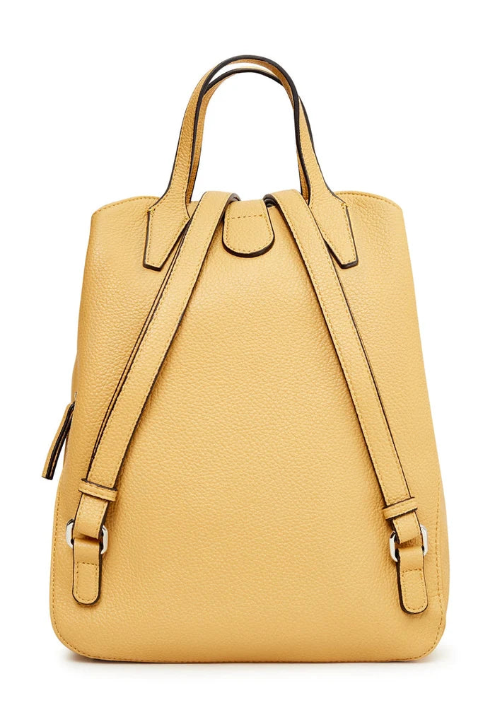 A trendy mustard leather backpack featuring a ring detail - the ultimate luxe accessory for your outfit.