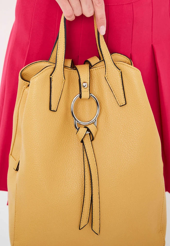 A trendy mustard leather backpack featuring a unique ring detail, perfect for carrying all your essentials in style.